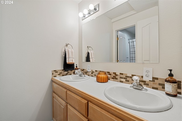 bathroom with decorative backsplash and vanity