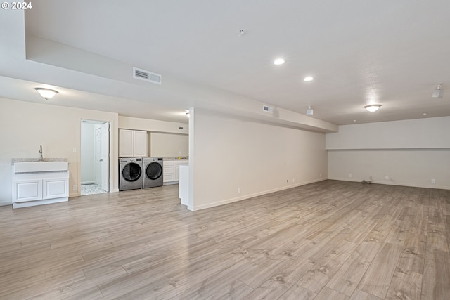 interior space with washer and clothes dryer and light hardwood / wood-style flooring