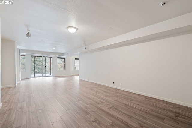 empty room featuring hardwood / wood-style floors and a textured ceiling