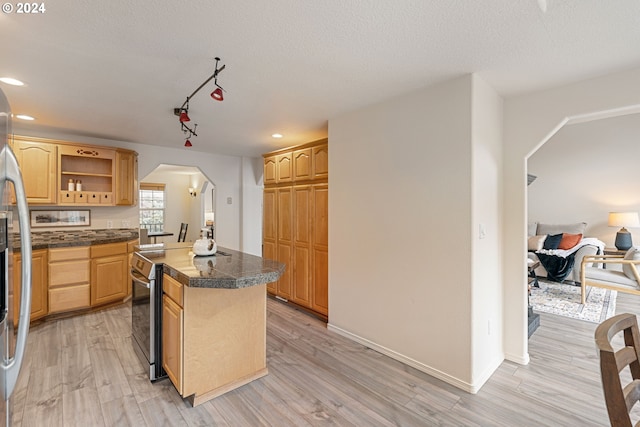 kitchen featuring a kitchen island, a textured ceiling, and light hardwood / wood-style flooring