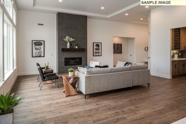 kitchen with tasteful backsplash, light stone countertops, a notable chandelier, pendant lighting, and dark hardwood / wood-style flooring