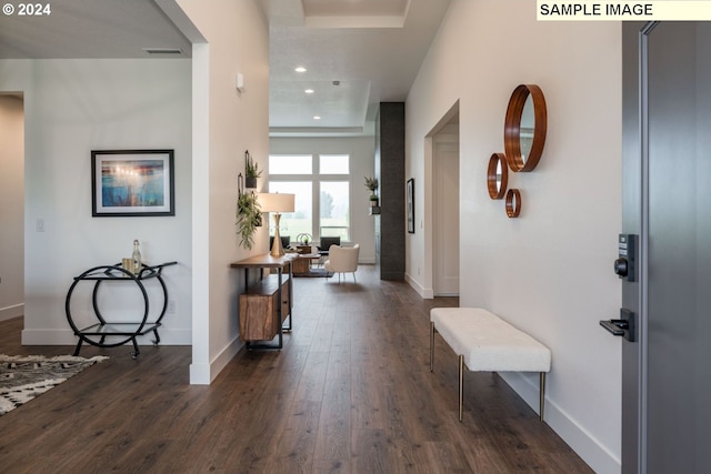 entrance foyer featuring dark wood-type flooring and an inviting chandelier