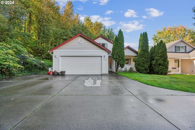 view of property with a front yard and a garage