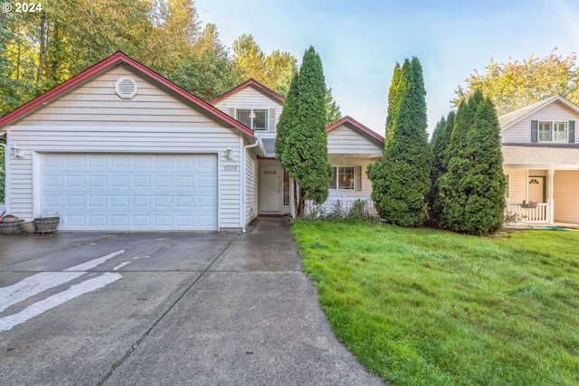 view of front of property featuring a front lawn and a garage