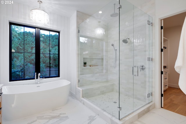 bathroom featuring separate shower and tub and wood walls