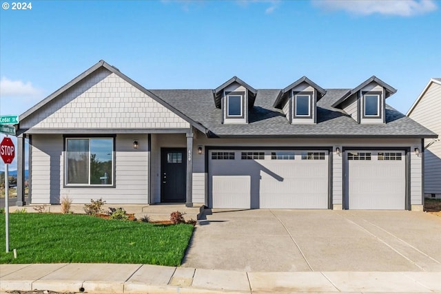 view of front of home featuring a garage and a front lawn