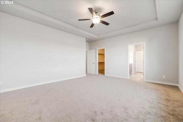 interior space featuring ceiling fan and a raised ceiling