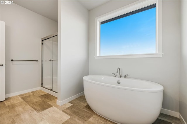 bathroom with shower with separate bathtub