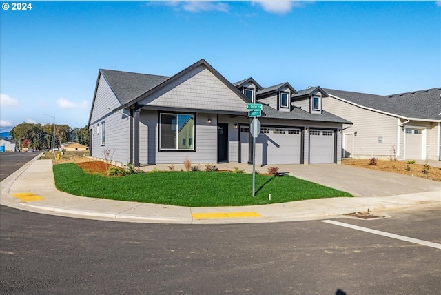 view of front of house with a front yard and a garage