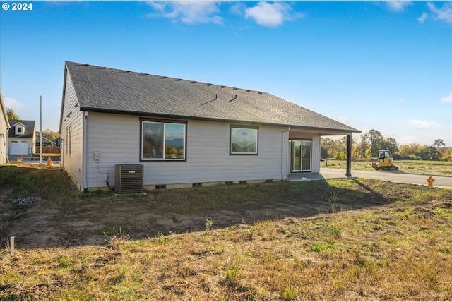 rear view of house featuring central AC