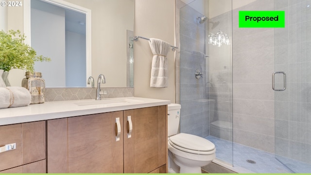 bathroom featuring a shower with door, vanity, and toilet