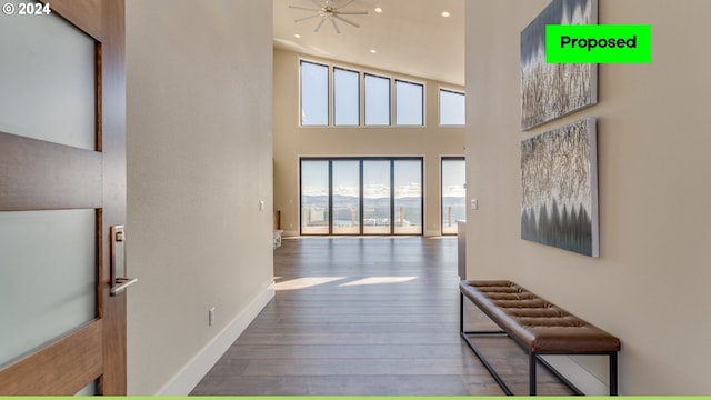 corridor featuring hardwood / wood-style floors and a high ceiling