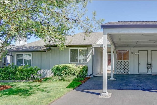 entrance to property with a lawn