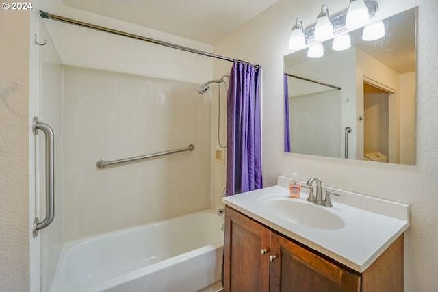 bathroom featuring vanity and shower / bath combination with curtain