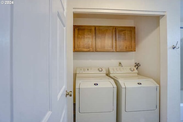 washroom with cabinets and independent washer and dryer