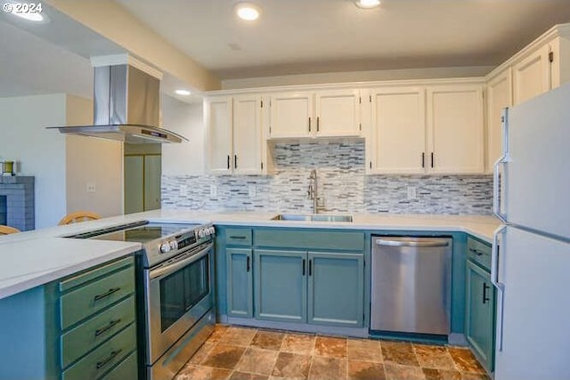 kitchen with white cabinets, ventilation hood, sink, decorative backsplash, and appliances with stainless steel finishes