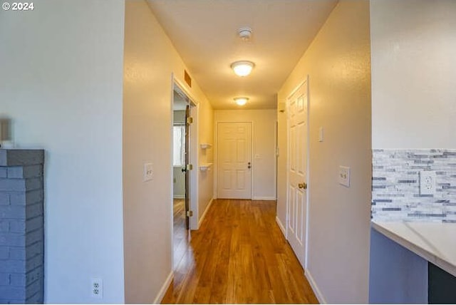 corridor with hardwood / wood-style floors