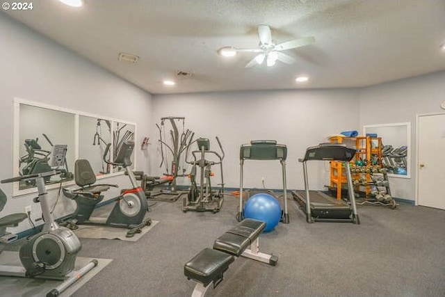 gym featuring a textured ceiling and ceiling fan