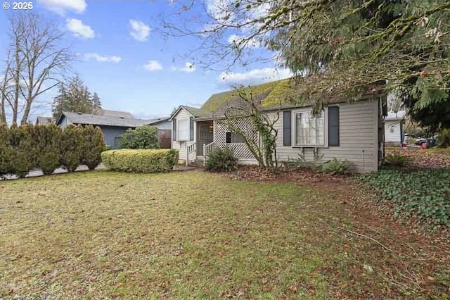 bungalow-style home with a front yard