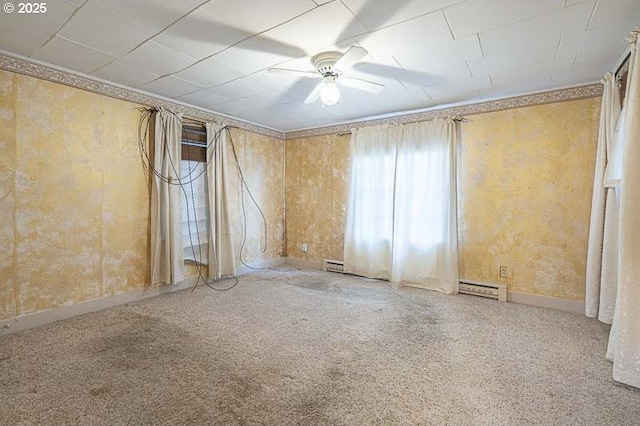 unfurnished room featuring baseboard heating, ceiling fan, and carpet