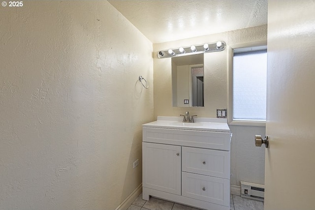 bathroom featuring vanity, tile patterned flooring, and a baseboard heating unit