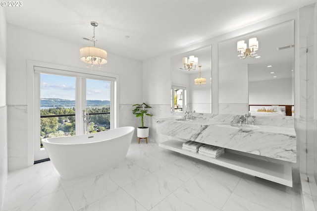 bathroom featuring vanity, a mountain view, a chandelier, and a bathtub