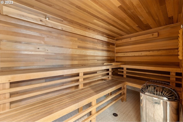 view of sauna with wood ceiling and wooden walls