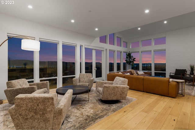 living room with a high ceiling and light wood-type flooring