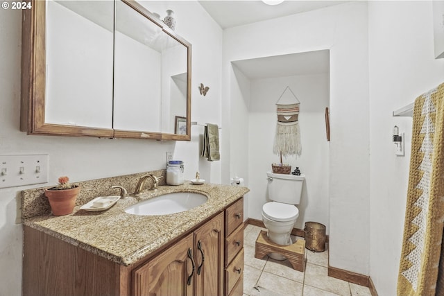 bathroom with vanity, tile patterned flooring, and toilet