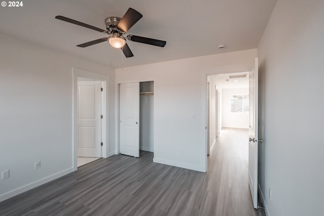 unfurnished bedroom with hardwood / wood-style floors, a closet, and ceiling fan