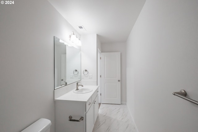 bathroom featuring vanity and toilet