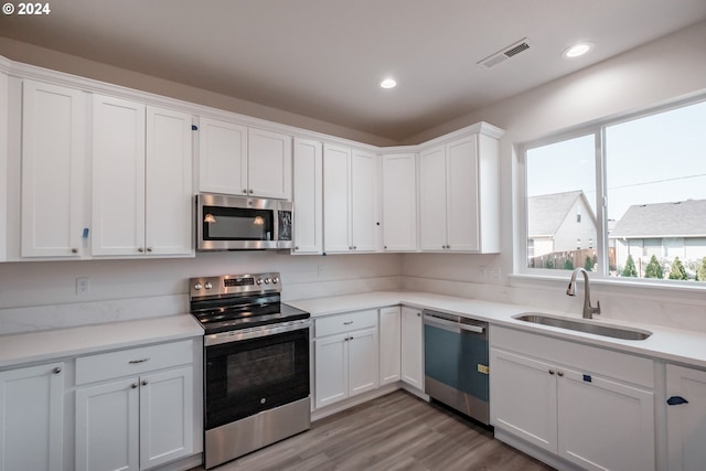 kitchen featuring white cabinetry, sink, and appliances with stainless steel finishes