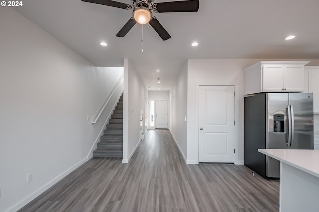 kitchen featuring white cabinets, stainless steel refrigerator with ice dispenser, light hardwood / wood-style flooring, and ceiling fan