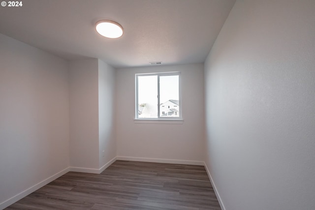 empty room with dark hardwood / wood-style flooring