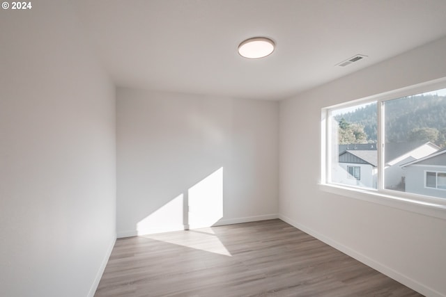 spare room featuring light wood-type flooring