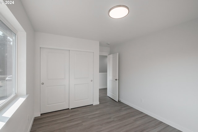 unfurnished bedroom featuring a closet and light hardwood / wood-style flooring