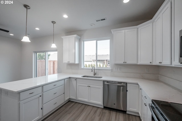 kitchen with hanging light fixtures, kitchen peninsula, sink, and stainless steel dishwasher