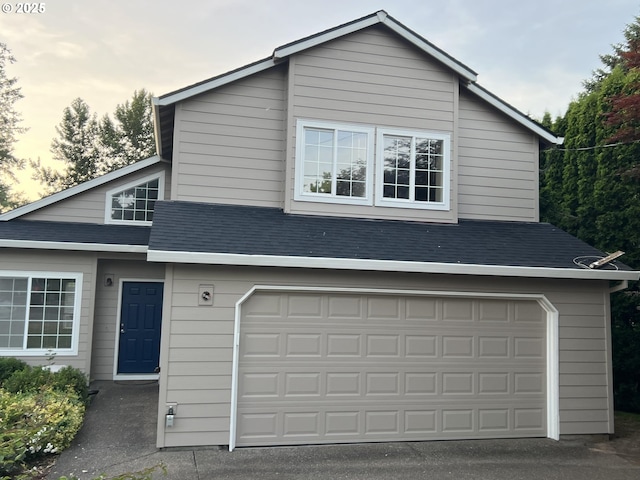 4135 SW Brugger St, Portland, OR 97219 - view of front of property with an attached garage and roof with shingles