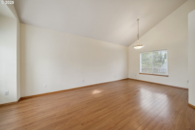 4135 SW Brugger St, Portland, OR 97219 - empty room with light wood-type flooring and high vaulted ceiling