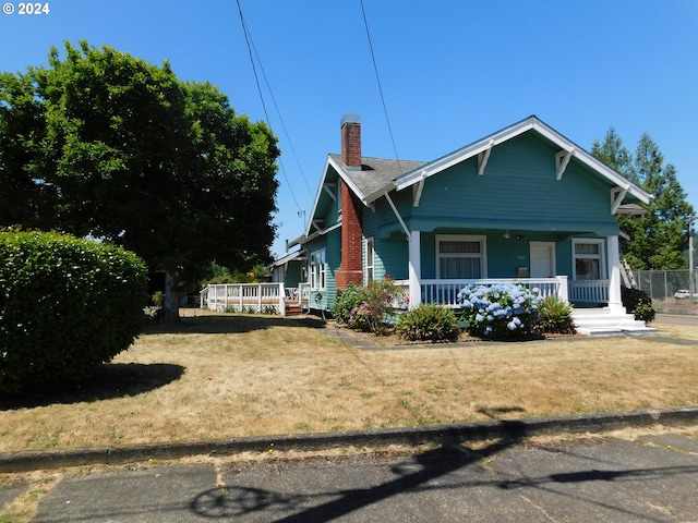 bungalow featuring a front yard and a porch