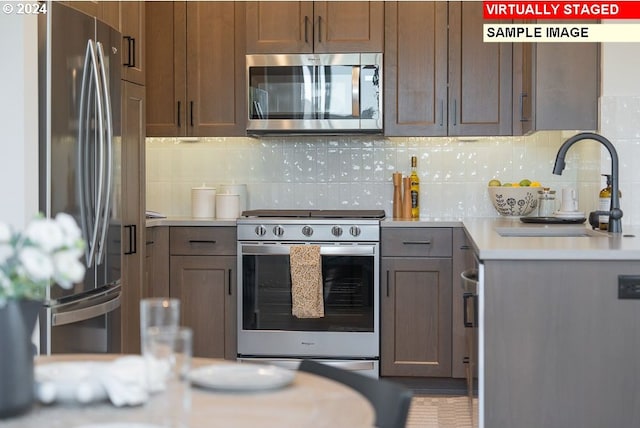 kitchen featuring sink, backsplash, and appliances with stainless steel finishes