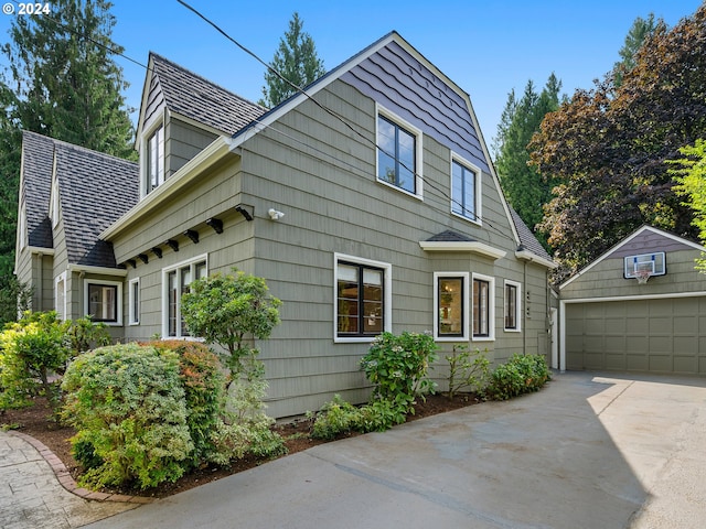 view of side of property featuring a garage and an outdoor structure