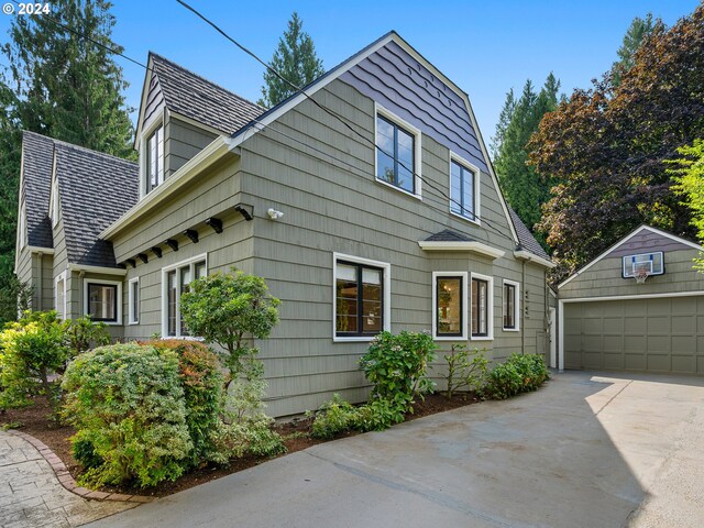 view of front of home with a garage and an outdoor structure