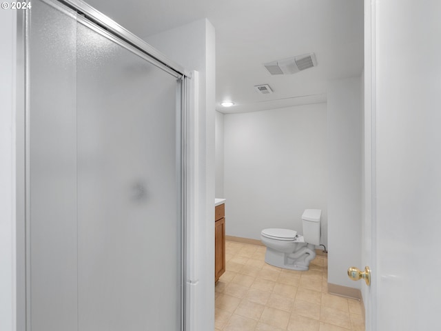 bathroom featuring tile patterned flooring, a shower with shower door, vanity, and toilet