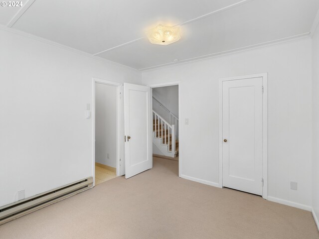 unfurnished bedroom with baseboard heating, light colored carpet, and ornamental molding