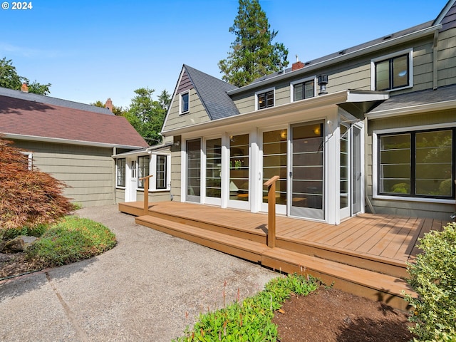 rear view of property featuring a wooden deck