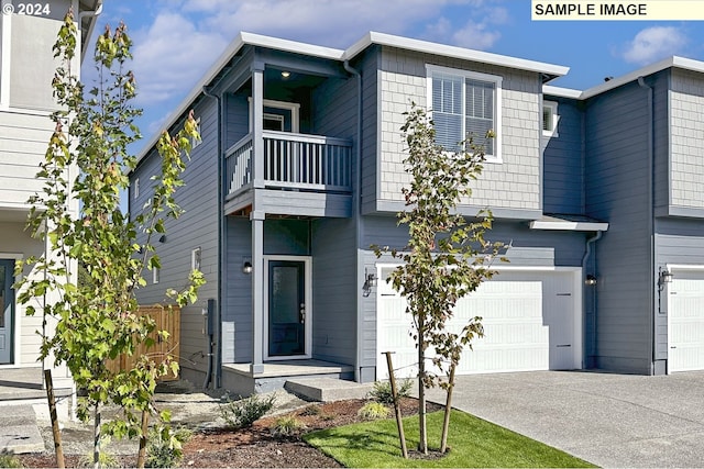 view of front facade featuring a garage and a balcony