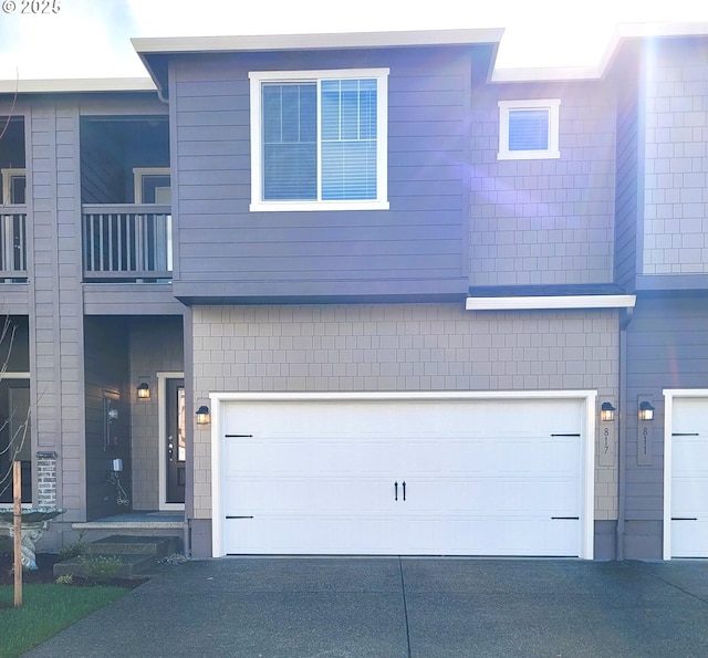 view of property featuring driveway and an attached garage