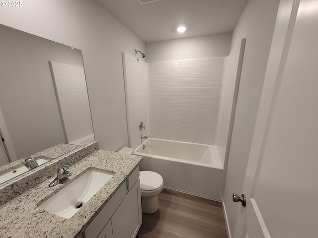 full bathroom with  shower combination, vanity, wood finished floors, and toilet