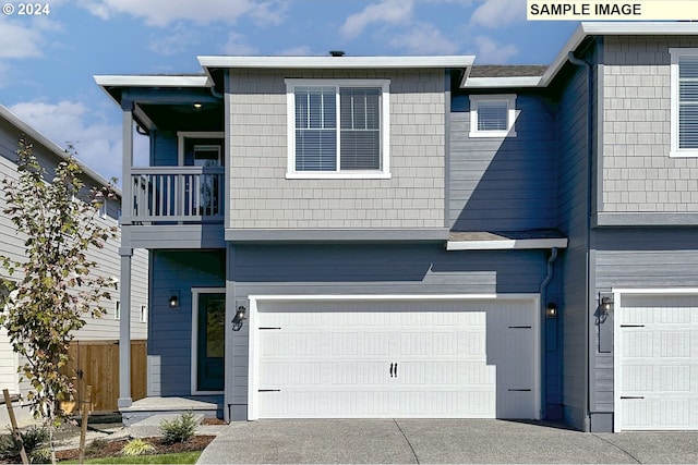 multi unit property featuring a balcony and a garage